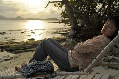 Relaxing on a beach chair at sunset at Caneel Beach