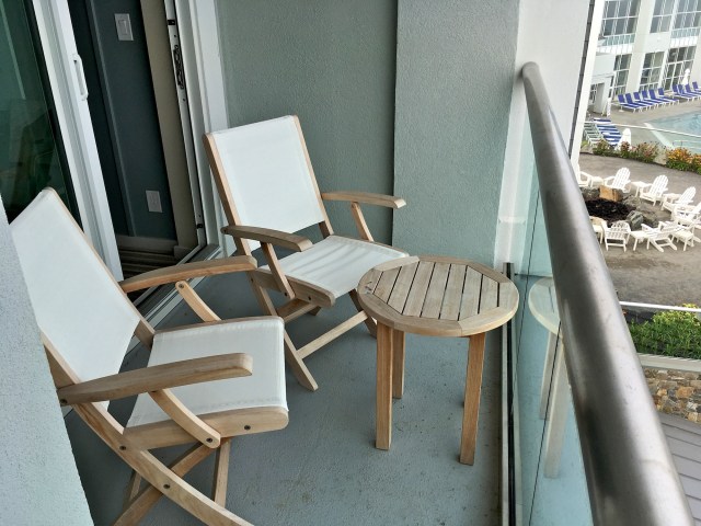 The balcony comes with two chairs and a coffee table