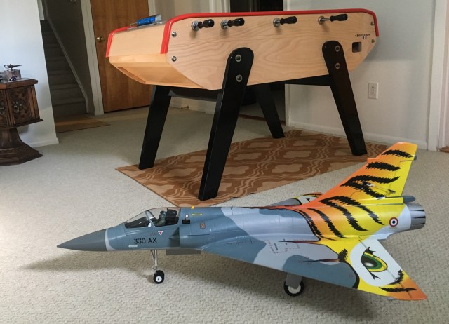 Freewing Mirage 2000 Tiger Meet , a French plane, in front of a French-style foosball table