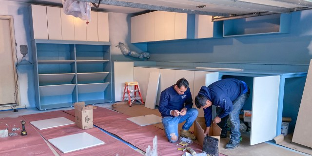 Painted cabinet doors are assembled onto frames