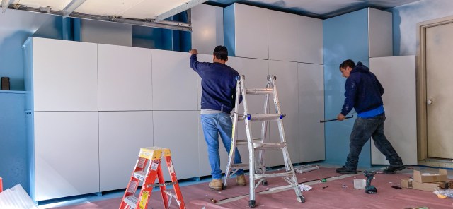 Painted cabinet doors are assembled onto frames