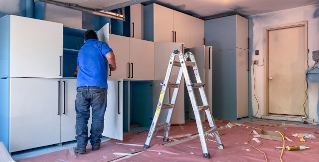 Handles are being installed on cabinet doors