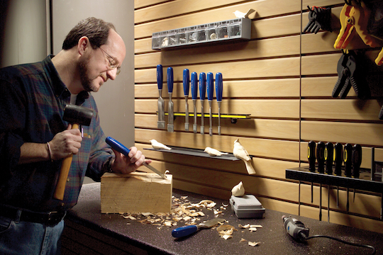 Workbench in a garage, with PVC slatwall panels.
