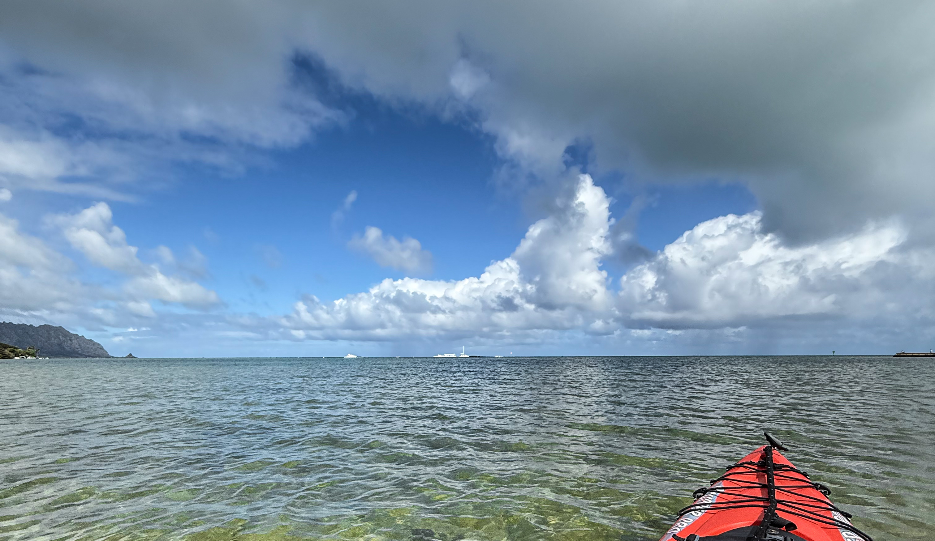 Kapapa Island looks deceptingly close just behind boats, but is actually very far away, behind the sandbar