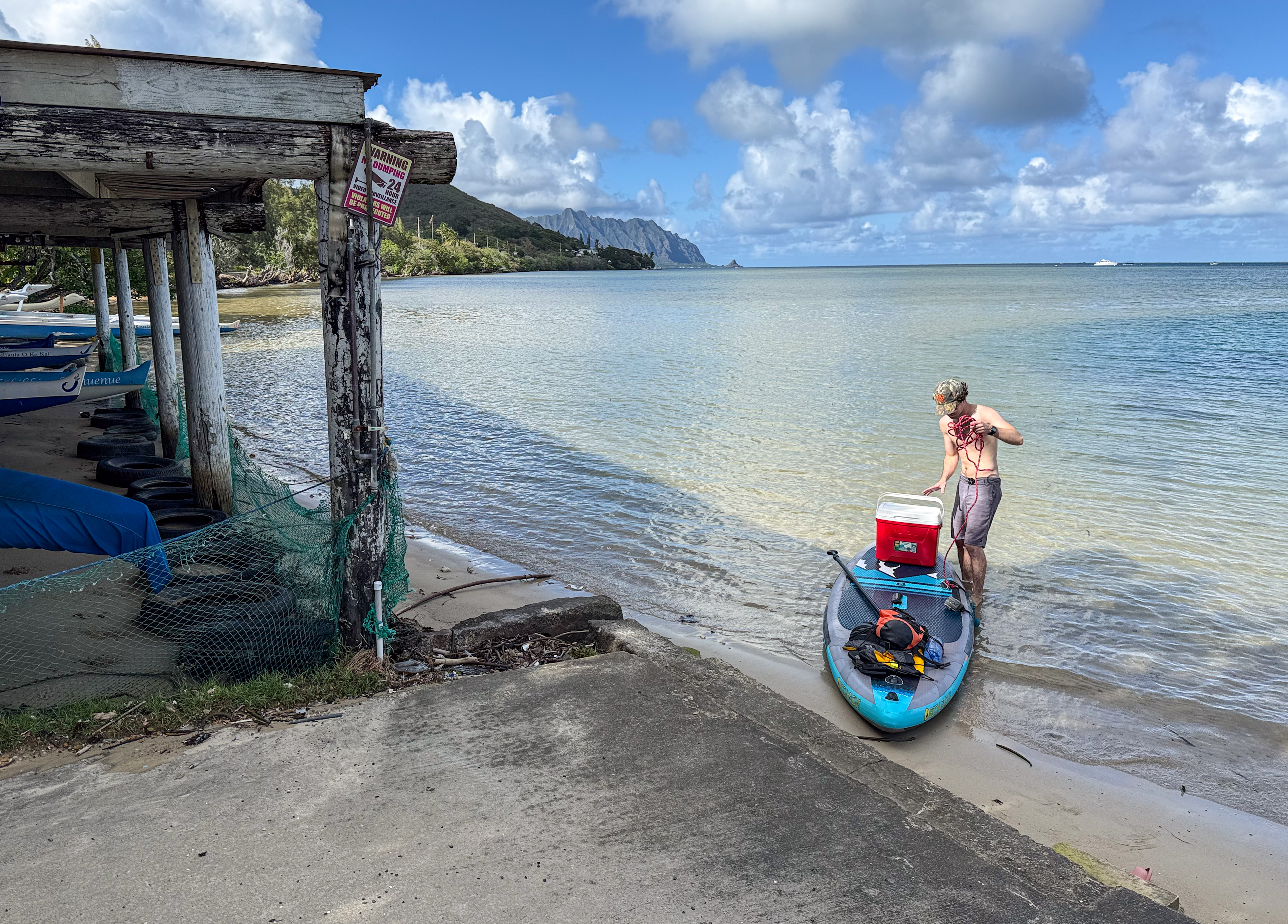 Lone standup paddler landing at the public boat launch at Kaneo Canoe Club