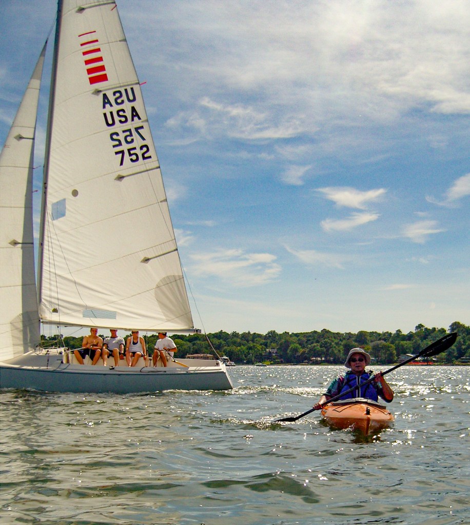 Sailboats races in Manhasset Bay -Crew hiking out on one side of the boat to balance the boat against wind