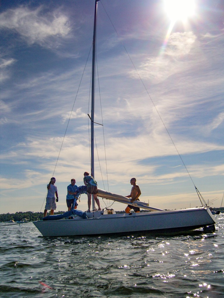 Sailboats races in Manhasset Bay -Crew unrigs a boat after a race