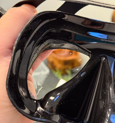 A sheet of water hugs the defog film in the center of the lens